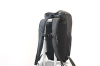Lumière Reflect Pro backpack mounted on a suitcase trolley handle via the trolley sleeve