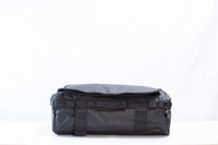 Lumière SHIFT 4-in-1 travel bag standing upright with side pocket holding an umbrella