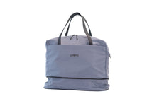 Lumière Utility travel duffel in grey with the expandable bottom compartment zipped open